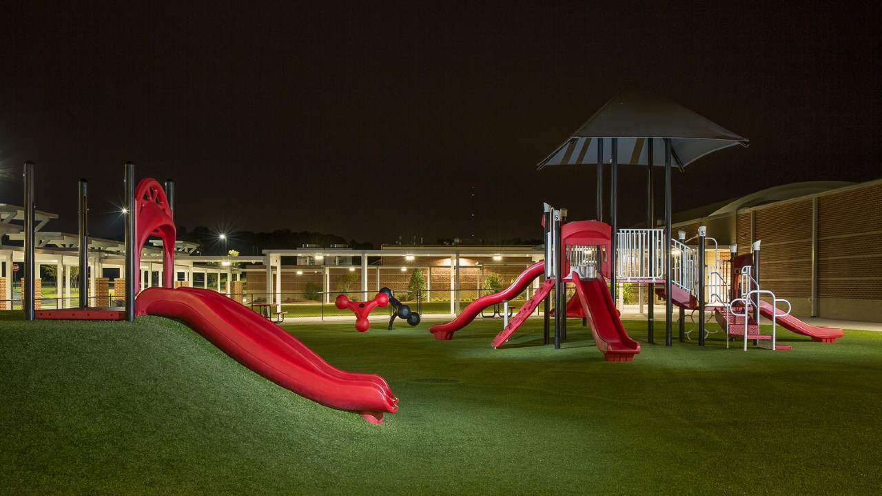 Nighttime artificial turf playground by Southwest Greens of Metro New York